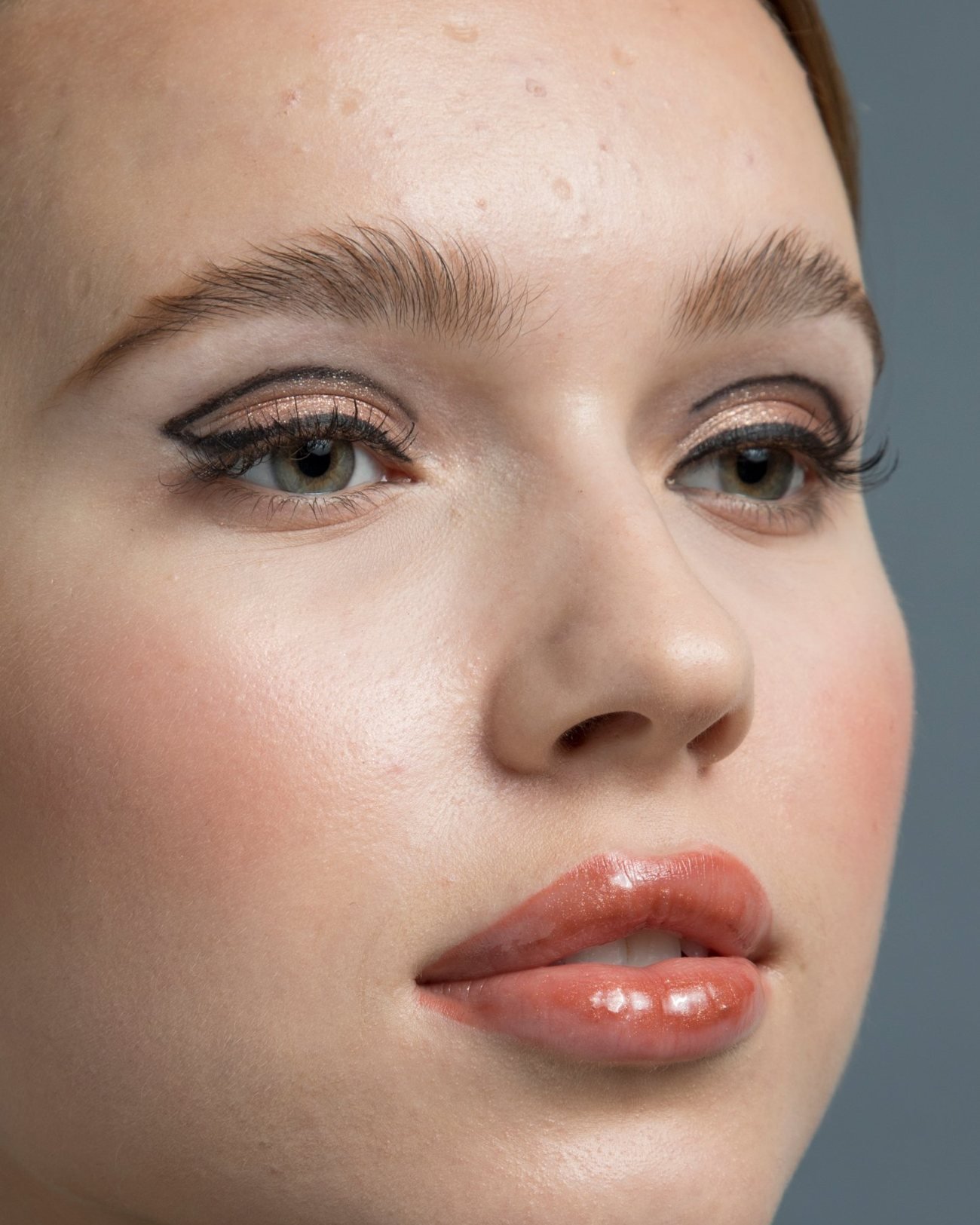 Beauty portrait before retouching: visible skin texture, blemishes and uneven tone