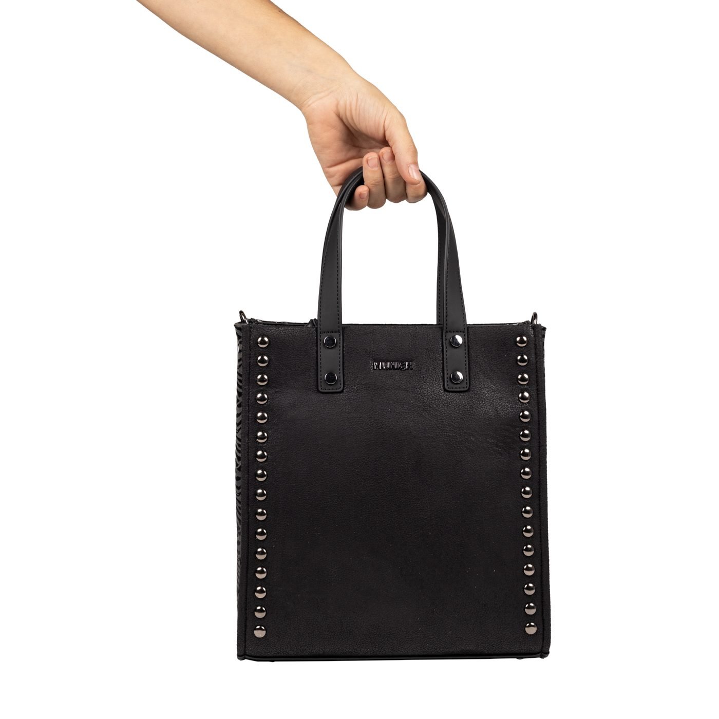 Munich Royal tote bag in black with gunmetal studs, held by hand, on white
